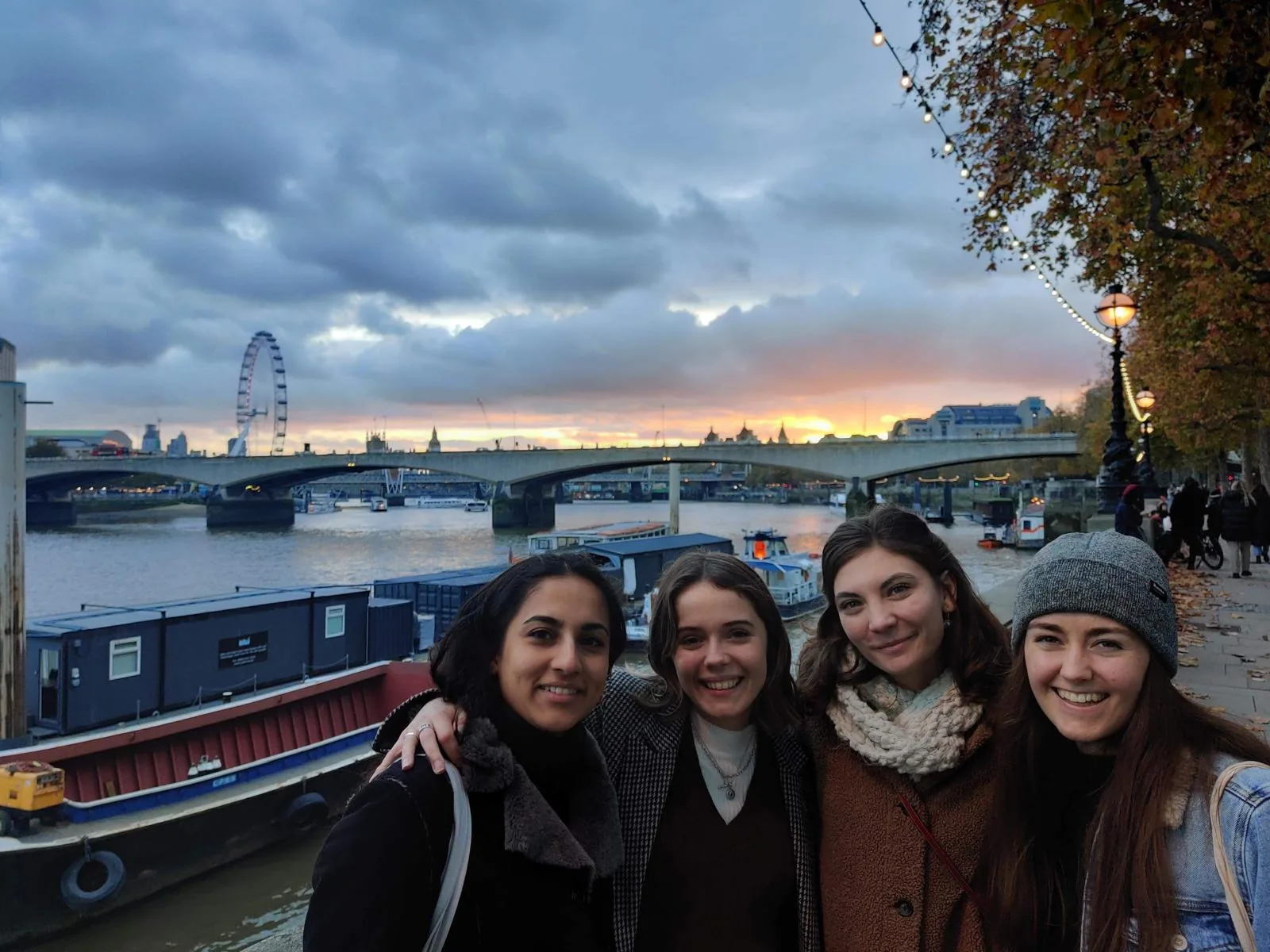 Friends by the Thames at sunset, London Eye behind