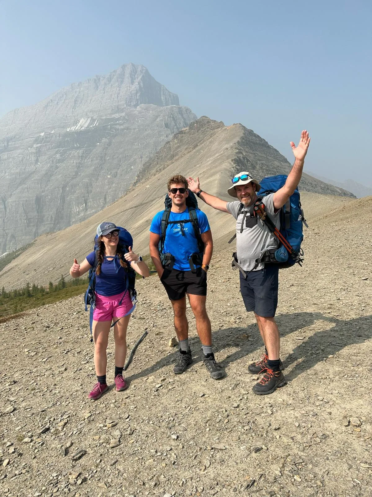 Backpacking trio at the top of a mountain