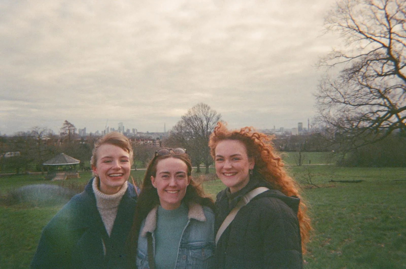 Friends on Primrose Hill with the London skyline