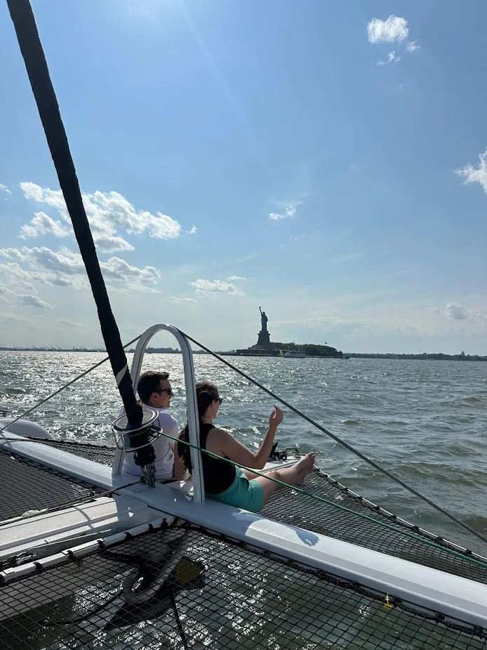 Tom and Morgan sailing past the Statue of Liberty